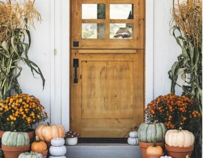 Decorating a porch for fall with pumpkins mums lanterns and autumn wreath